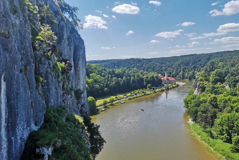 Links hängen die Arbeiter im Seil, im Hintergrund das bekannte Kloster Weltenburg. Fotos: Markus Ixmeier